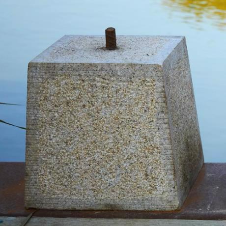 Granite, tapered square, staddle stone with iron pin